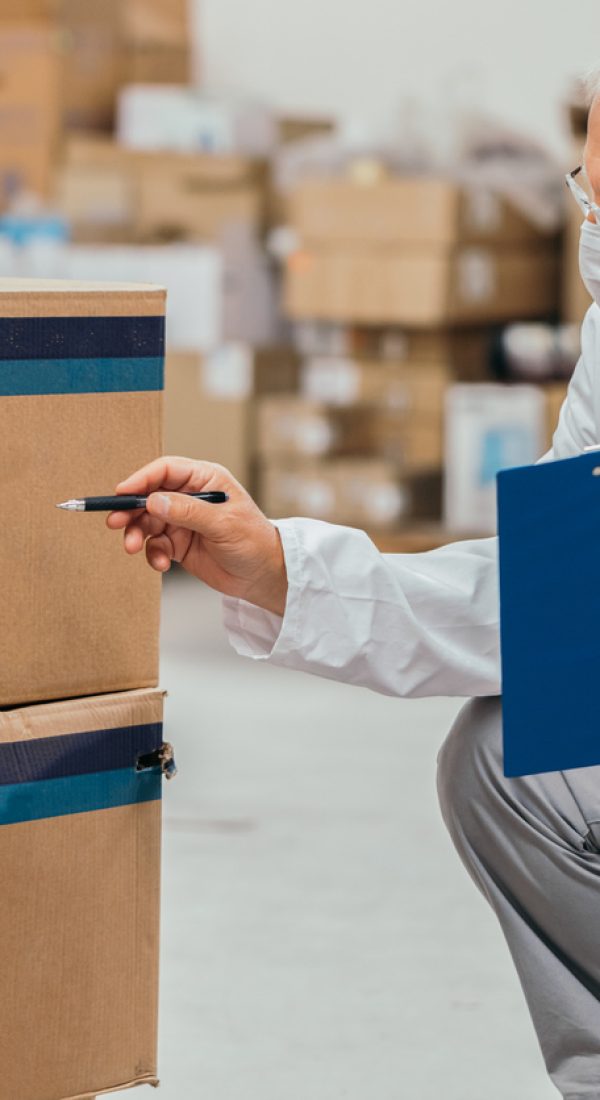 Senior doctor checking medical stock in a warehouse Senior doctor checking medical stock in a warehouse