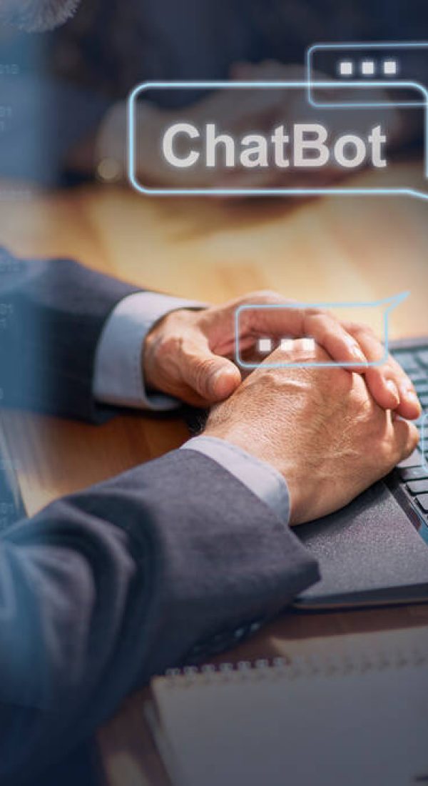 stock-photo-man-sitting-desk-chatting-chatbot-using-laptop-computer stock-photo-man-sitting-desk-chatting-chatbot-using-laptop-computer